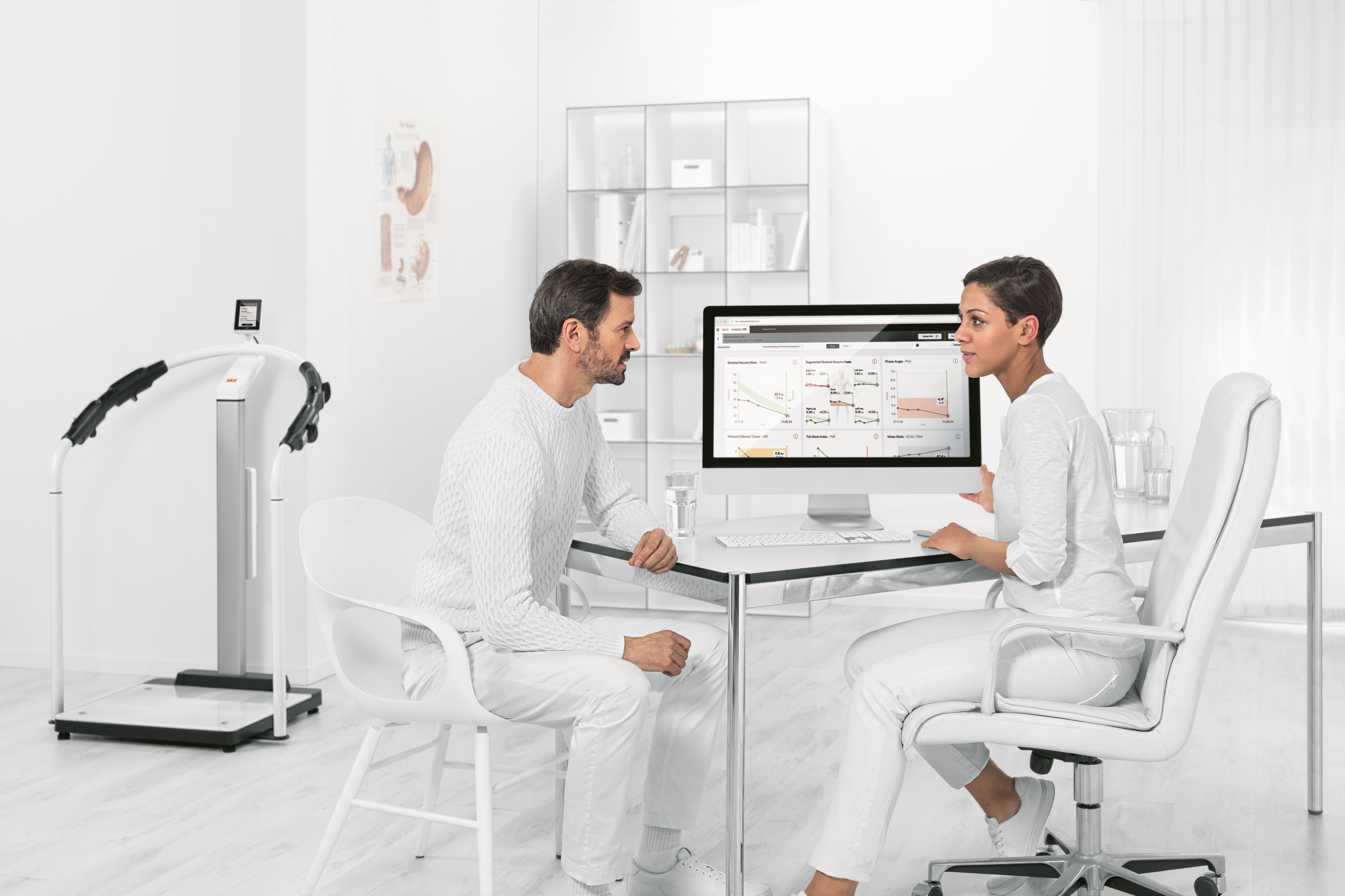 Two healthcare professionals sitting in front of a computer and analyzing data gathered from social media
